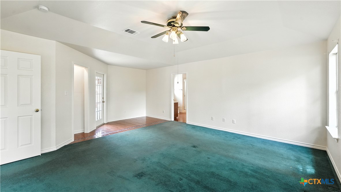 220 Lanier Ranch Road Driftwood, TX 78619 - Photo 22 of 48 a view of a big room with windows and chandelier fan