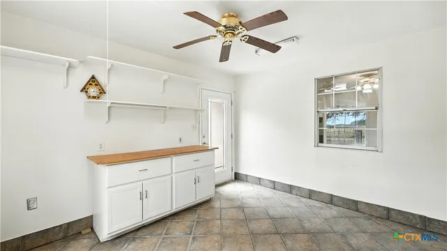 a kitchen with a cabinets and window