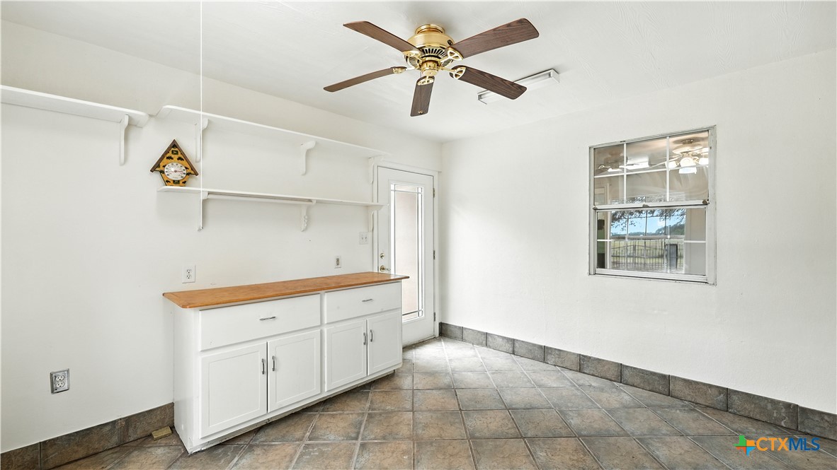 220 Lanier Ranch Road Driftwood, TX 78619 - Photo 28 of 48 a kitchen with a cabinets and window