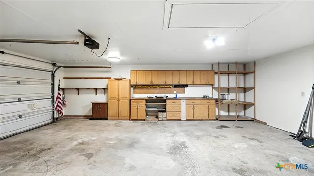 a view of a kitchen with cabinet and a refrigerator