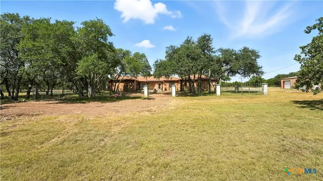 a house view with swimming pool in front of the house