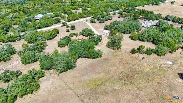 an aerial view of residential house with green space