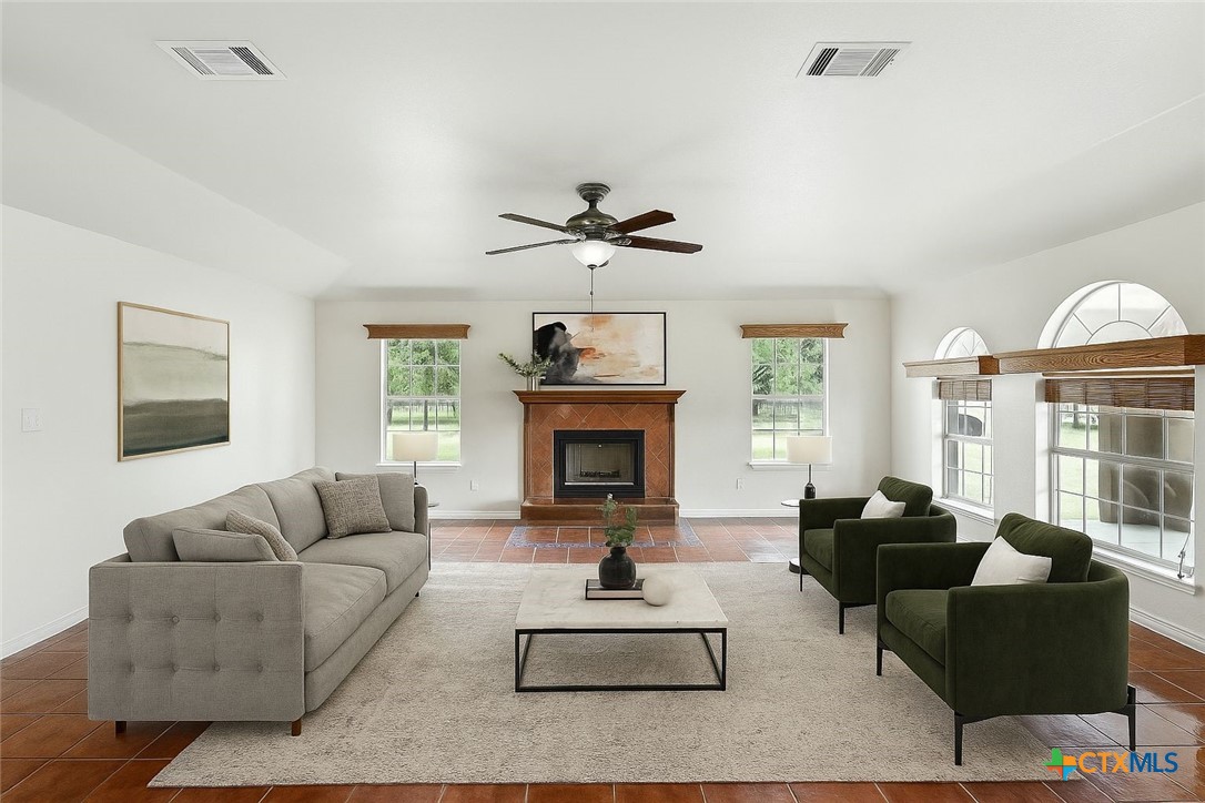 220 Lanier Ranch Road Driftwood, TX 78619 - Photo 6 of 48 a living room with furniture a fireplace and a large window