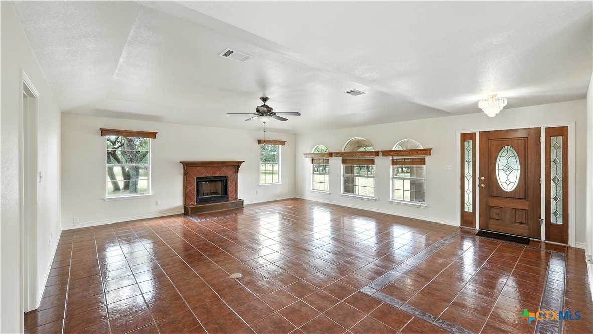 220 Lanier Ranch Road Driftwood, TX 78619 - Photo 8 of 48 a view of an empty room with a window and wooden floor
