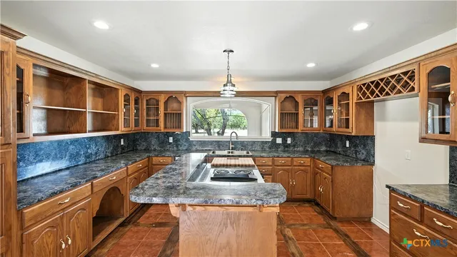 a kitchen with stainless steel appliances granite countertop sink stove and granite counter top