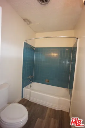 a bathroom with a toilet and a bathtub