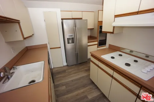 a kitchen with metallic refrigerator and a stove
