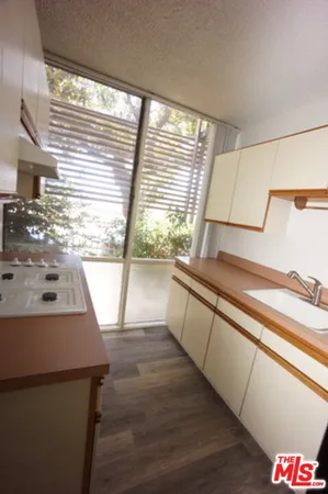 a view of a kitchen with wooden floor and a sink