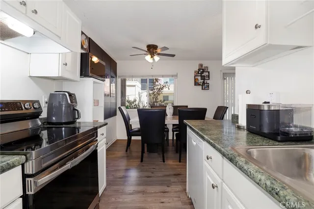 a kitchen with sink stove and cabinets