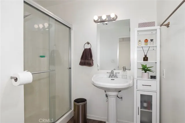 a bathroom with a sink a mirror and shower