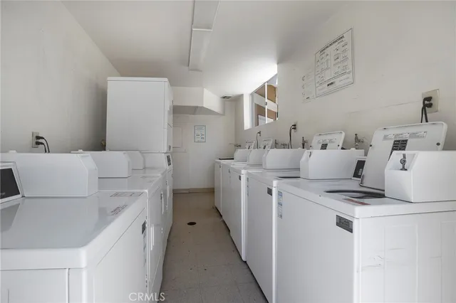 a view of a patio with chairs and potted plants