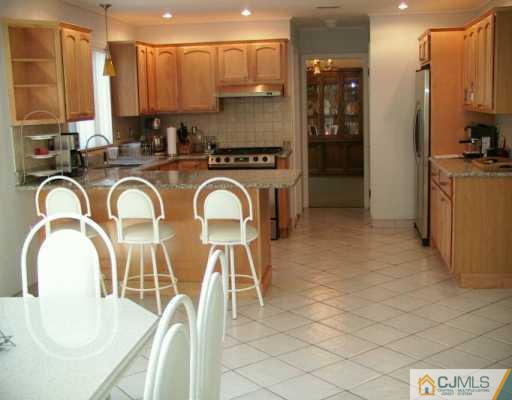 33 South Cliff Road Colonia, NJ 07067 - Photo 2 of 7 a kitchen with stainless steel appliances granite countertop a stove a sink and a refrigerator