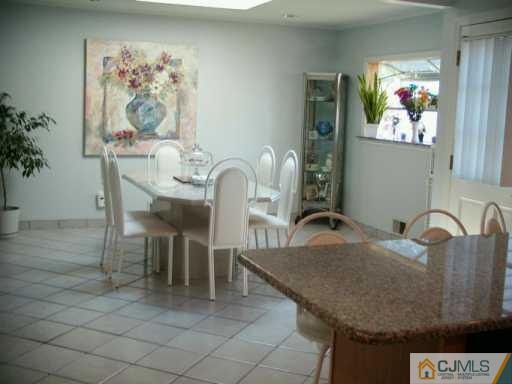 33 South Cliff Road Colonia, NJ 07067 - Photo 3 of 7 a dining room with furniture and painting on the wall