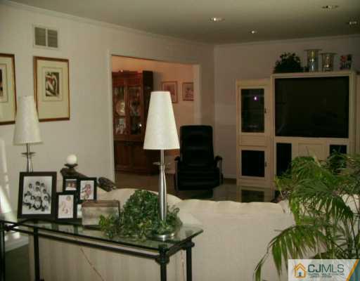 33 South Cliff Road Colonia, NJ 07067 - Photo 4 of 7 a living room with furniture and a flat screen tv