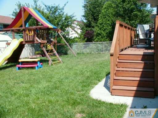 33 South Cliff Road Colonia, NJ 07067 - Photo 7 of 7 a view of wooden deck with a backyard