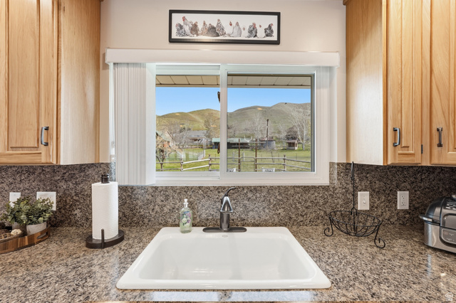 2420 West Old Hwy Road Morgan, UT 84050 - Photo 14 of 54 Kitchen view of light wood finish cabinetry, tasteful backsplash, and dark stone counters