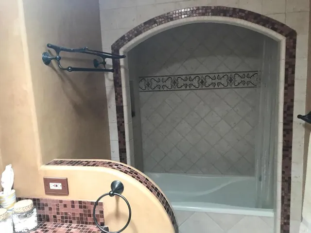a bathroom with a shower and a mirror