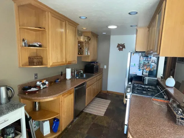 a kitchen with a sink stove and refrigerator