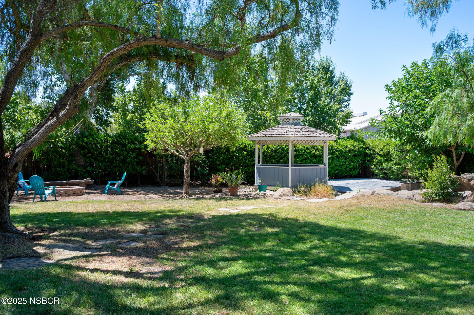 1011 North Refugio Road Santa Ynez, CA 93463 - Photo 38 of 48 a wooden bench sitting in the middle of a yard