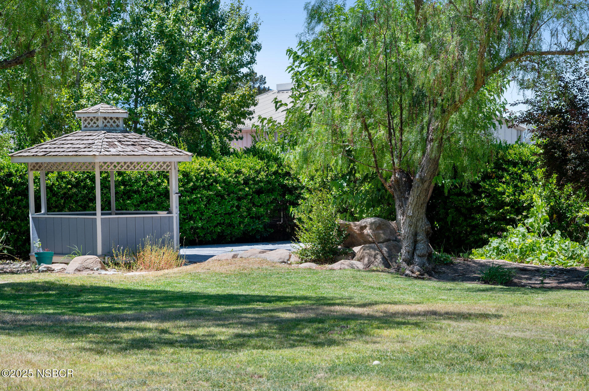 1011 North Refugio Road Santa Ynez, CA 93463 - Photo 41 of 48 a view of a table and chairs under an umbrella