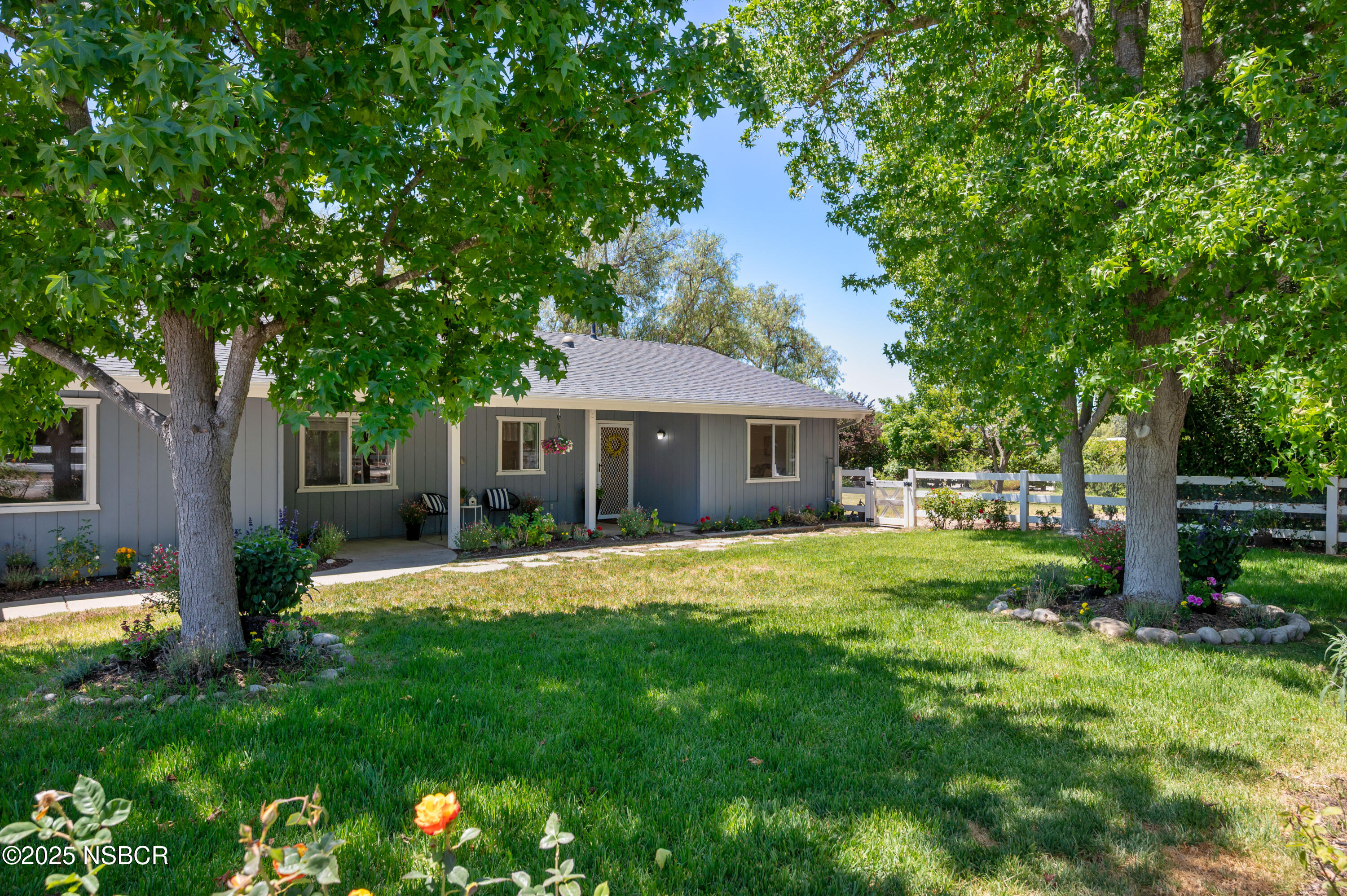 1011 North Refugio Road Santa Ynez, CA 93463 - Photo 7 of 48 a front view of a house with a garden