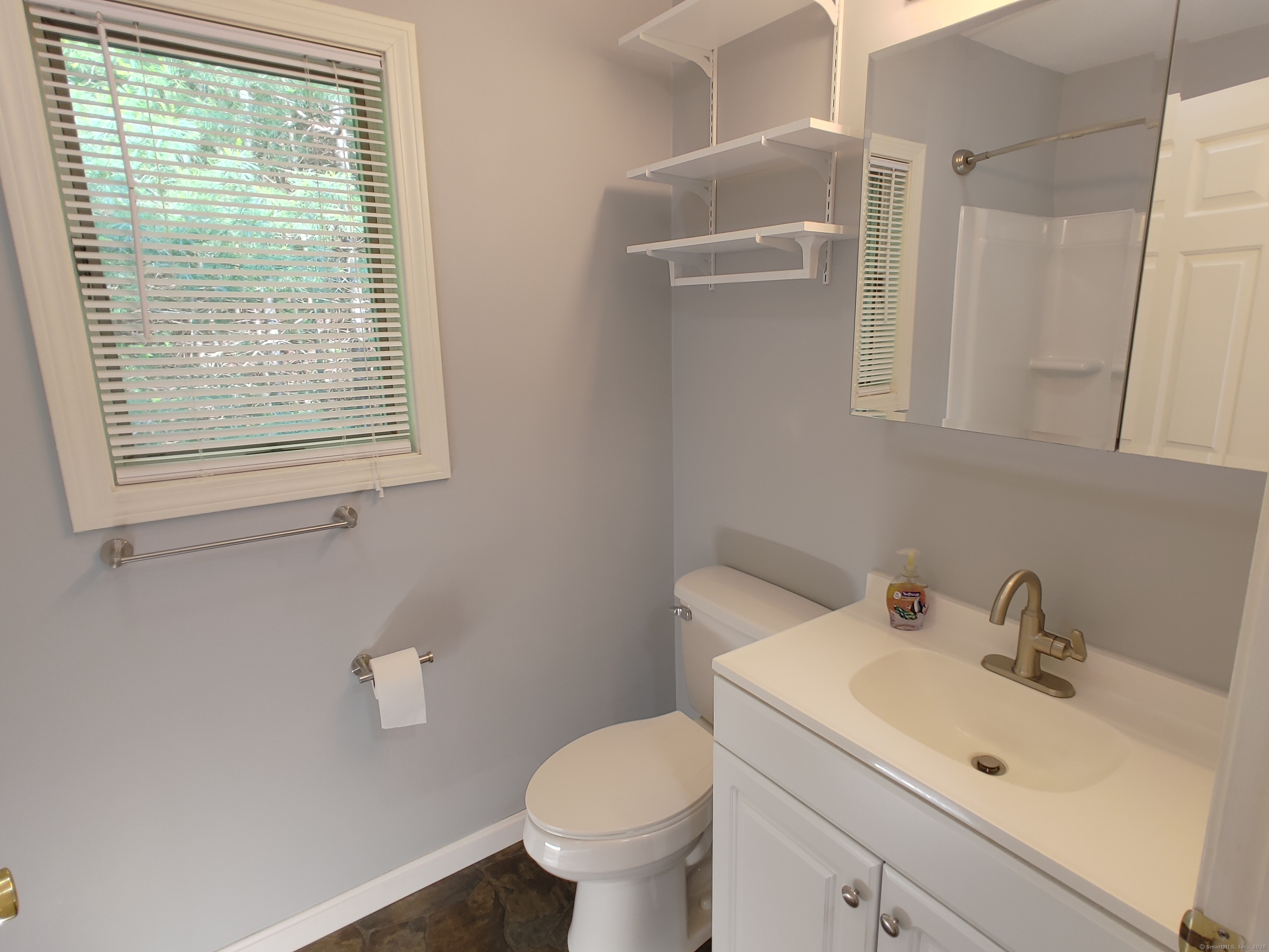 402 Whetstone Mills, Unit 402 Dayville, CT 06241 - Photo 11 of 21 a bathroom with a toilet sink and mirror
