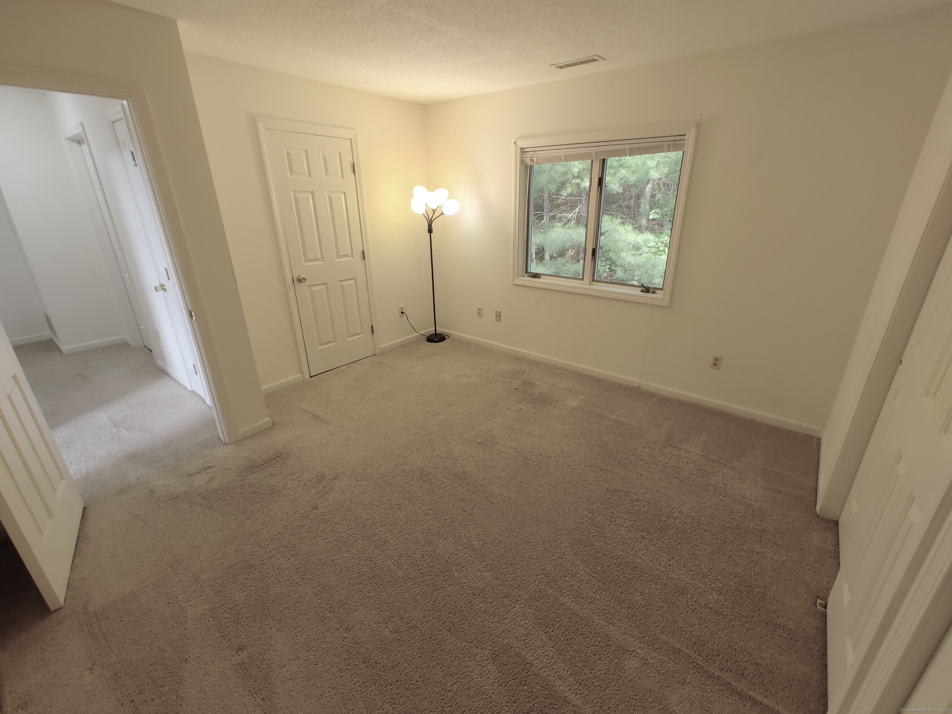 402 Whetstone Mills, Unit 402 Dayville, CT 06241 - Photo 17 of 21 an empty room with windows and closet