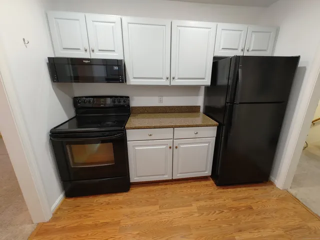 a kitchen with a stove and a refrigerator