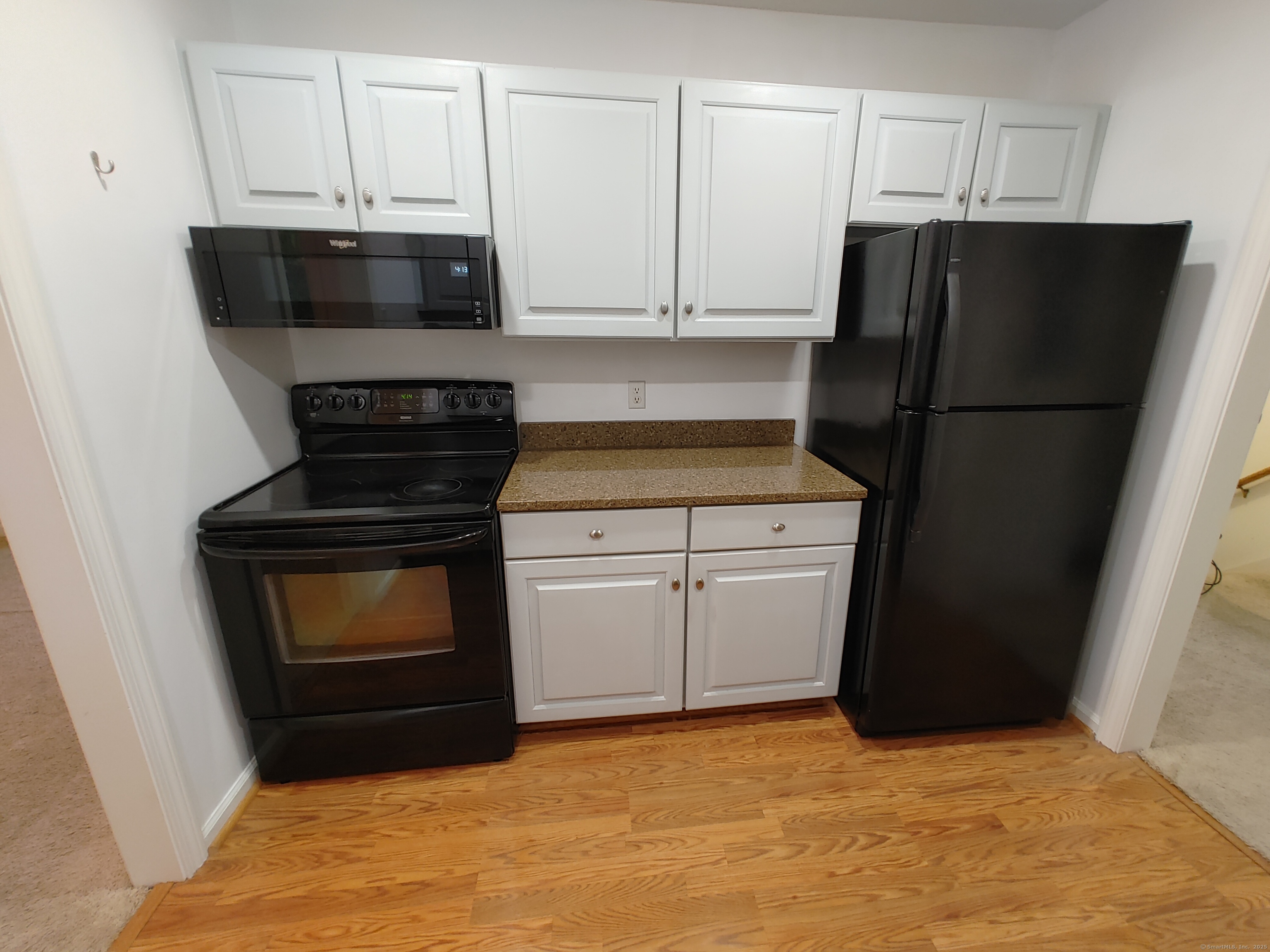402 Whetstone Mills, Unit 402 Dayville, CT 06241 - Photo 3 of 21 a kitchen with a stove and a refrigerator