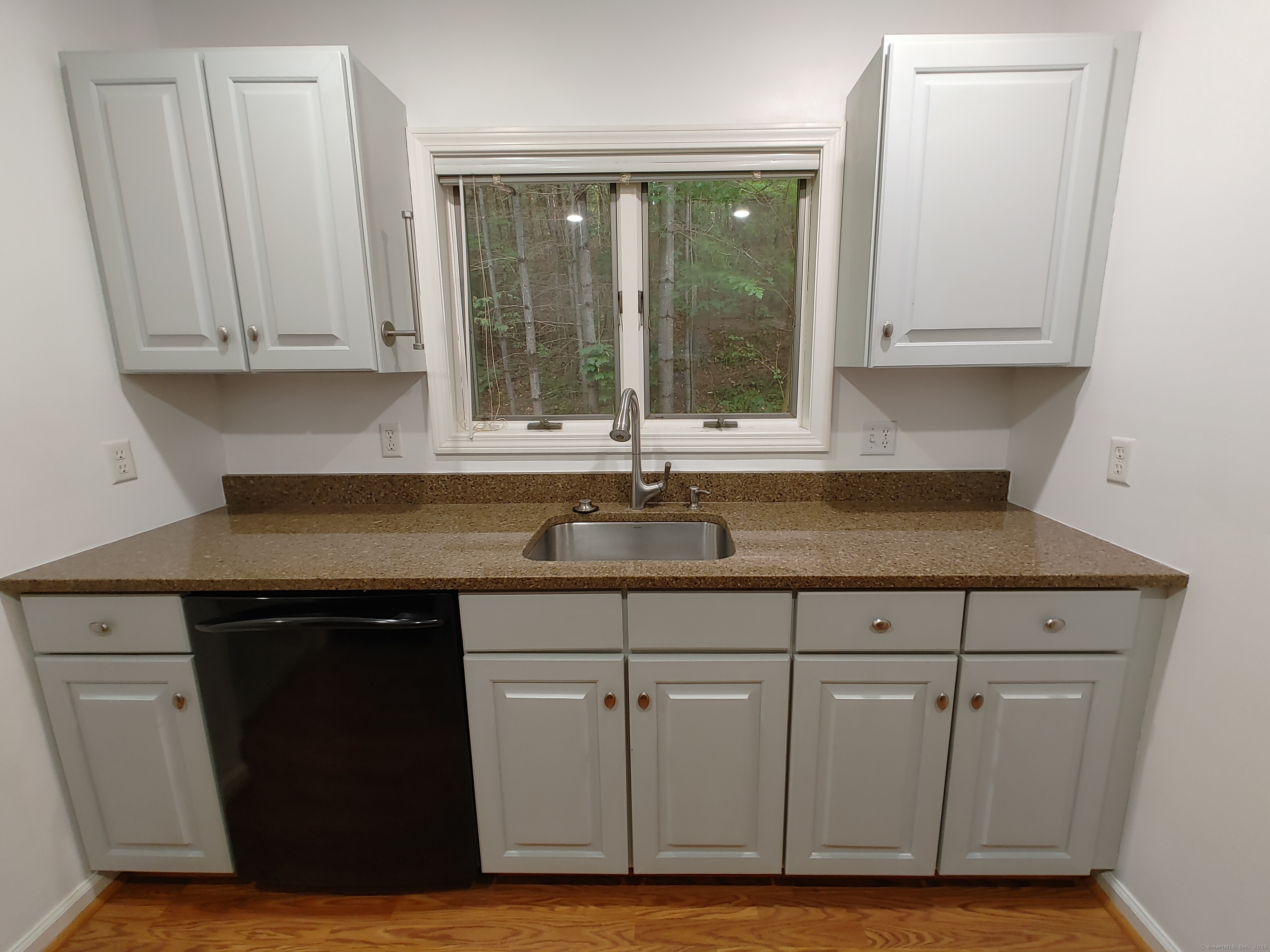 402 Whetstone Mills, Unit 402 Dayville, CT 06241 - Photo 4 of 21 a kitchen with granite countertop cabinets and sink