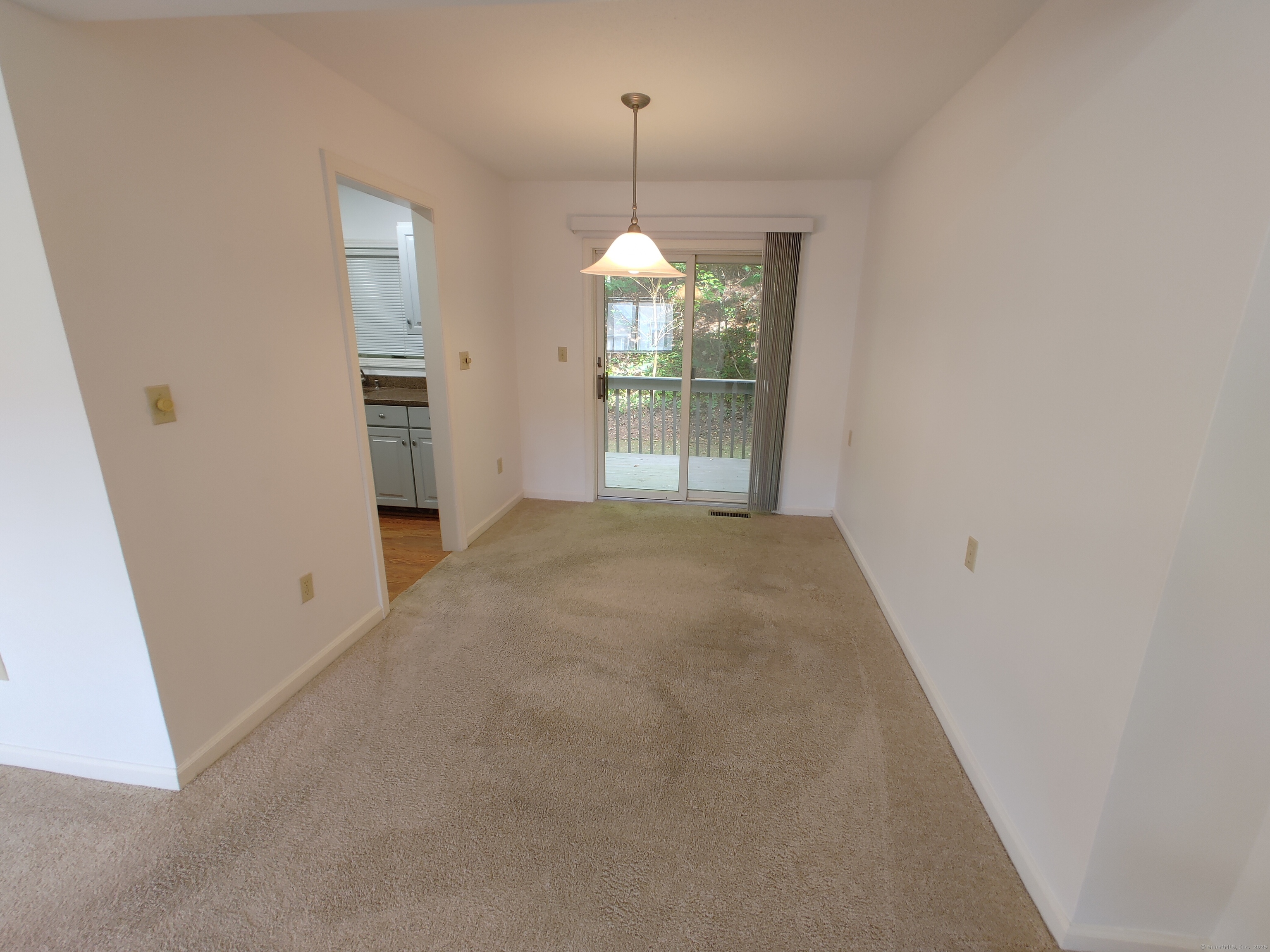 402 Whetstone Mills, Unit 402 Dayville, CT 06241 - Photo 6 of 21 en empty room with windows and outdoor view