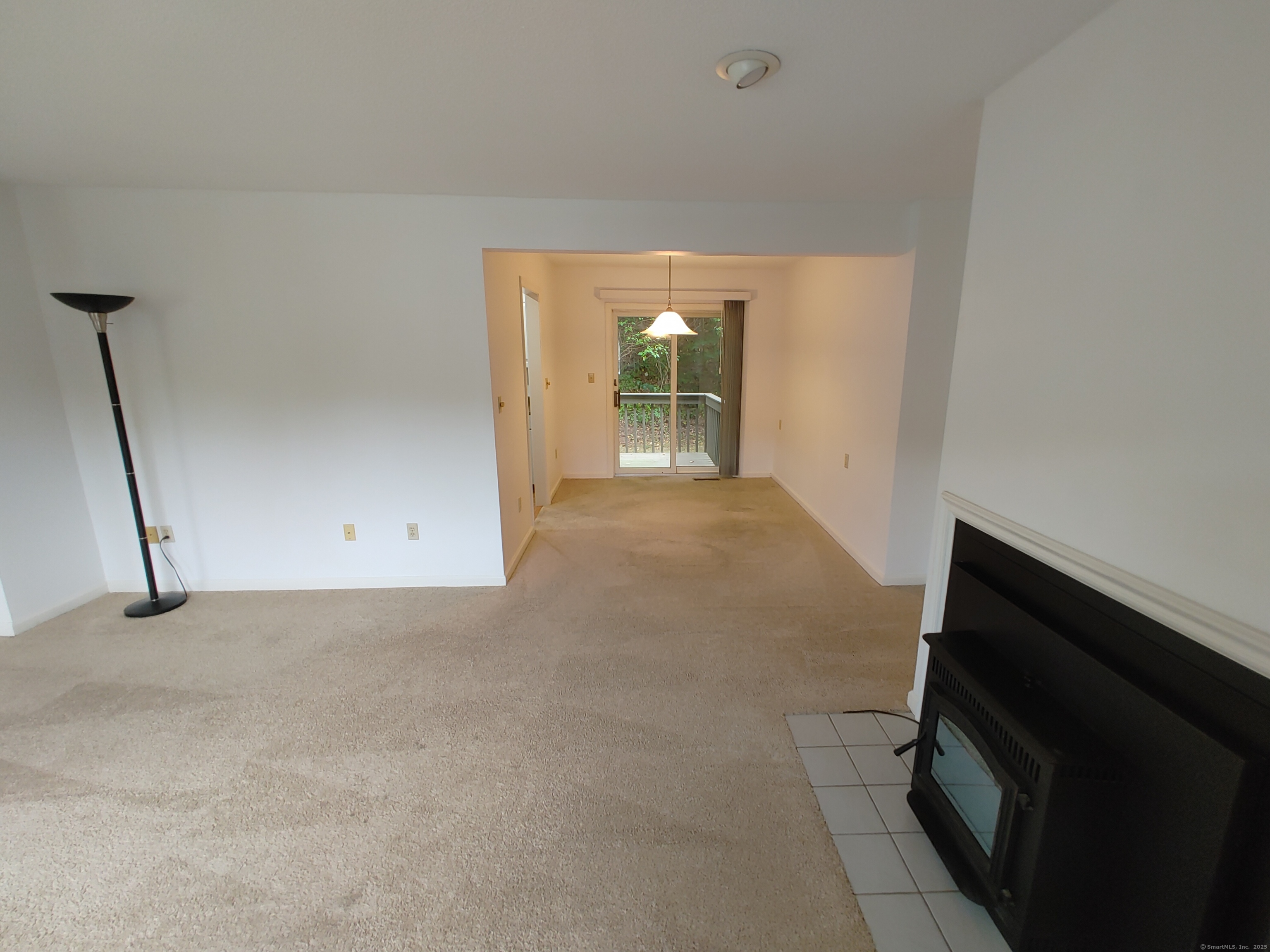 402 Whetstone Mills, Unit 402 Dayville, CT 06241 - Photo 7 of 21 a view of a room with an empty space and a fireplace