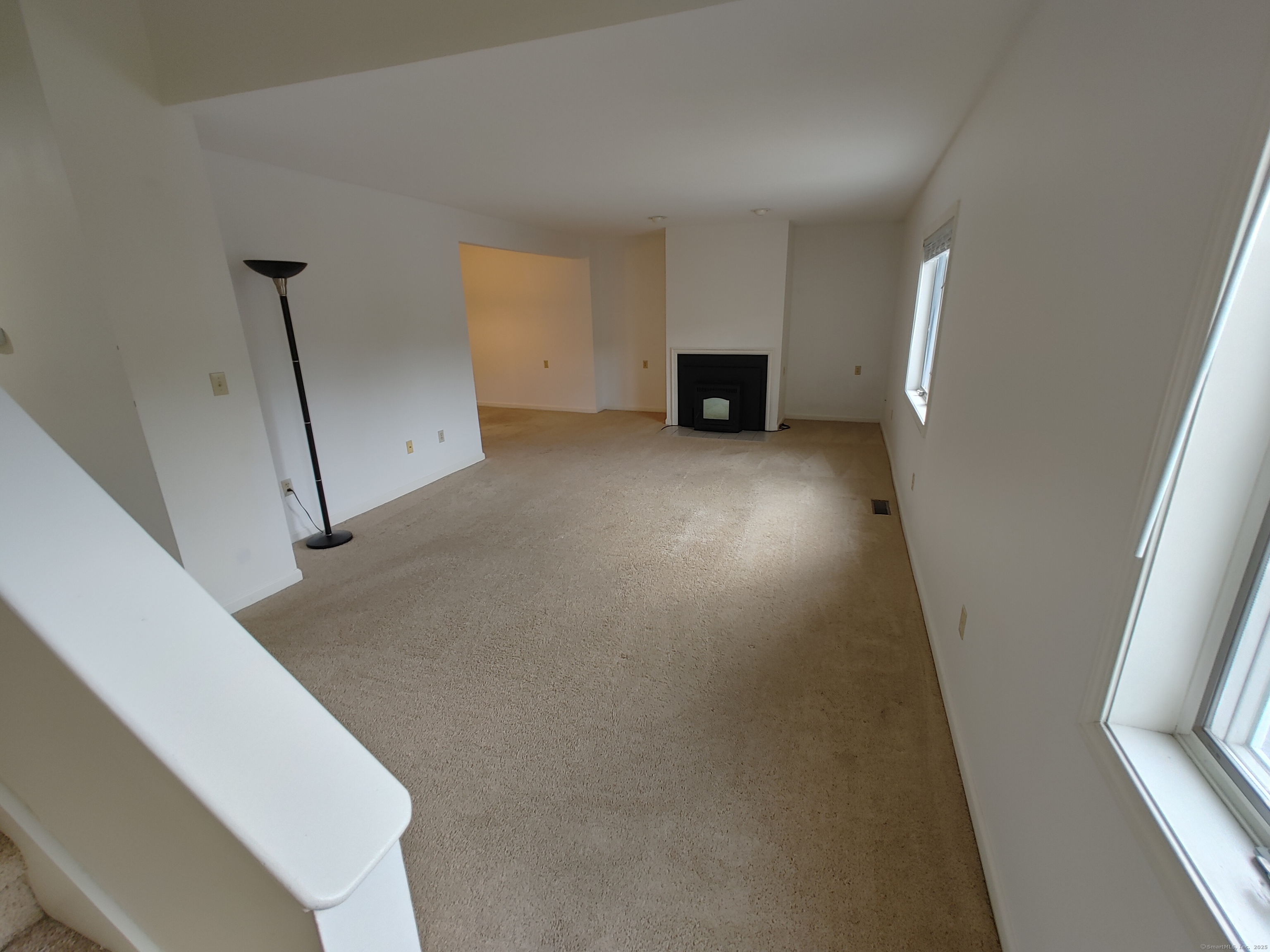 402 Whetstone Mills, Unit 402 Dayville, CT 06241 - Photo 8 of 21 a view of empty room with wooden floor and fan