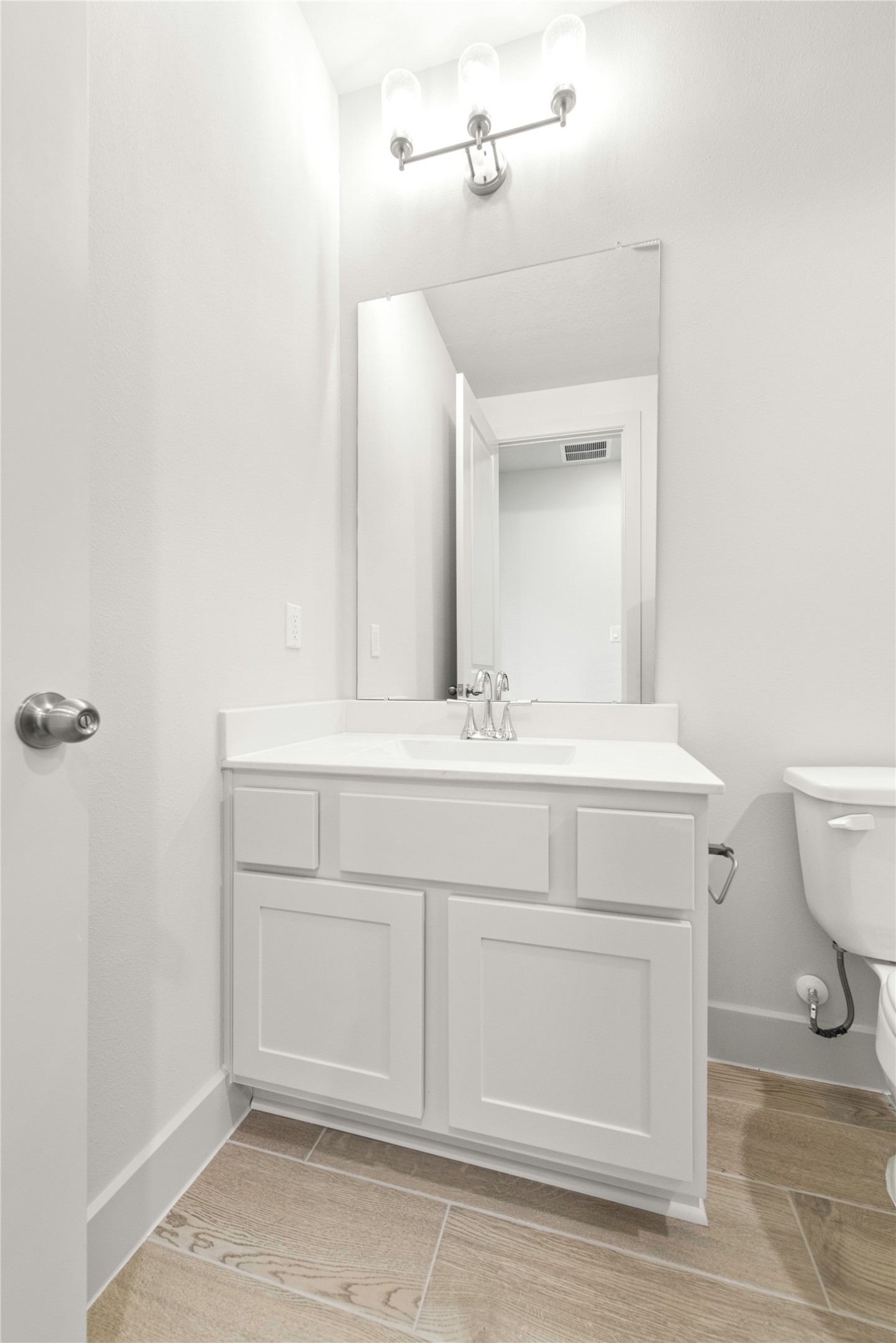 206 Sierra Stream Lane Conroe, TX 77304 - Photo 13 of 28 a bathroom with a sink vanity and a toilet