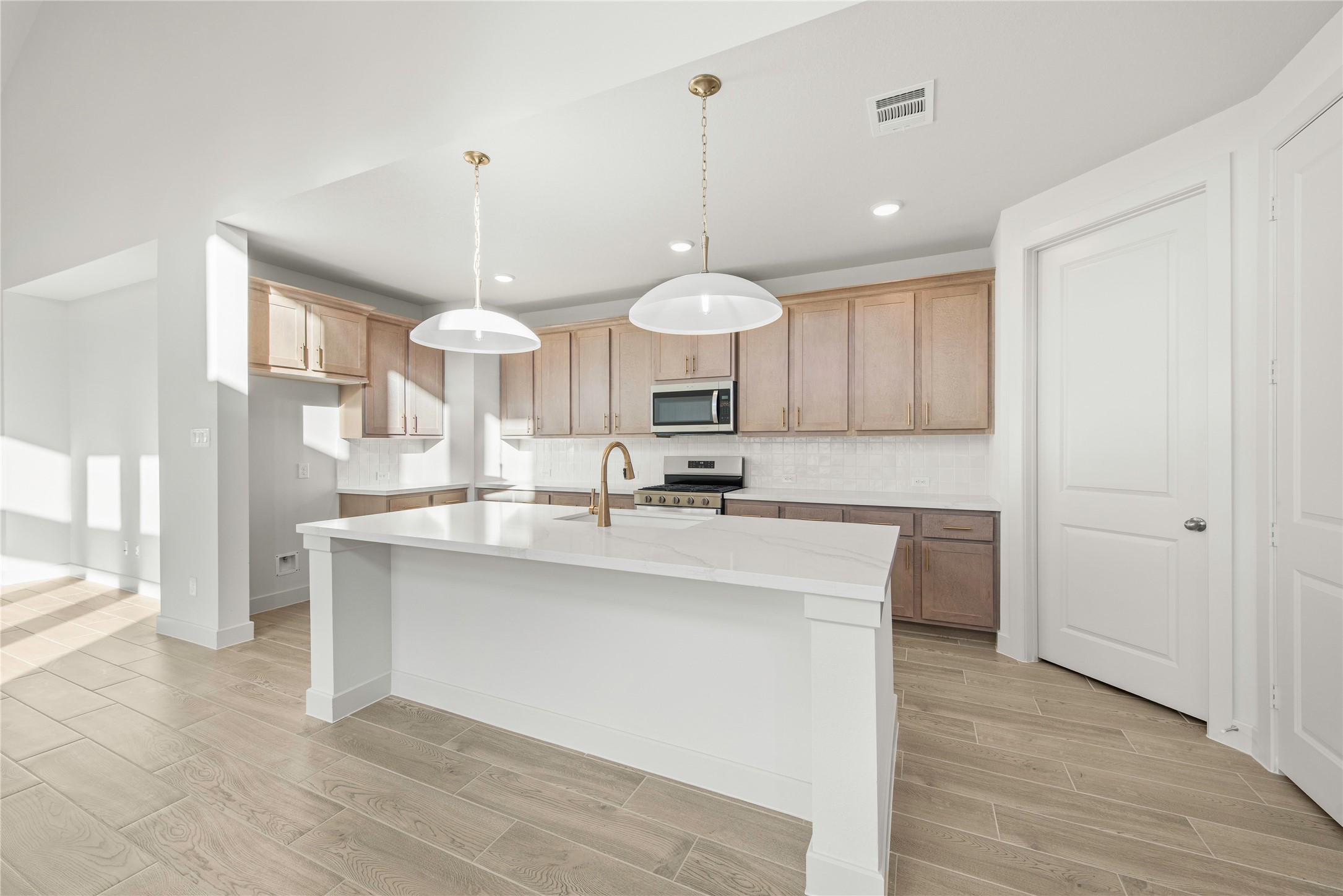 206 Sierra Stream Lane Conroe, TX 77304 - Photo 6 of 28 a large kitchen with a sink stainless steel appliances and cabinets