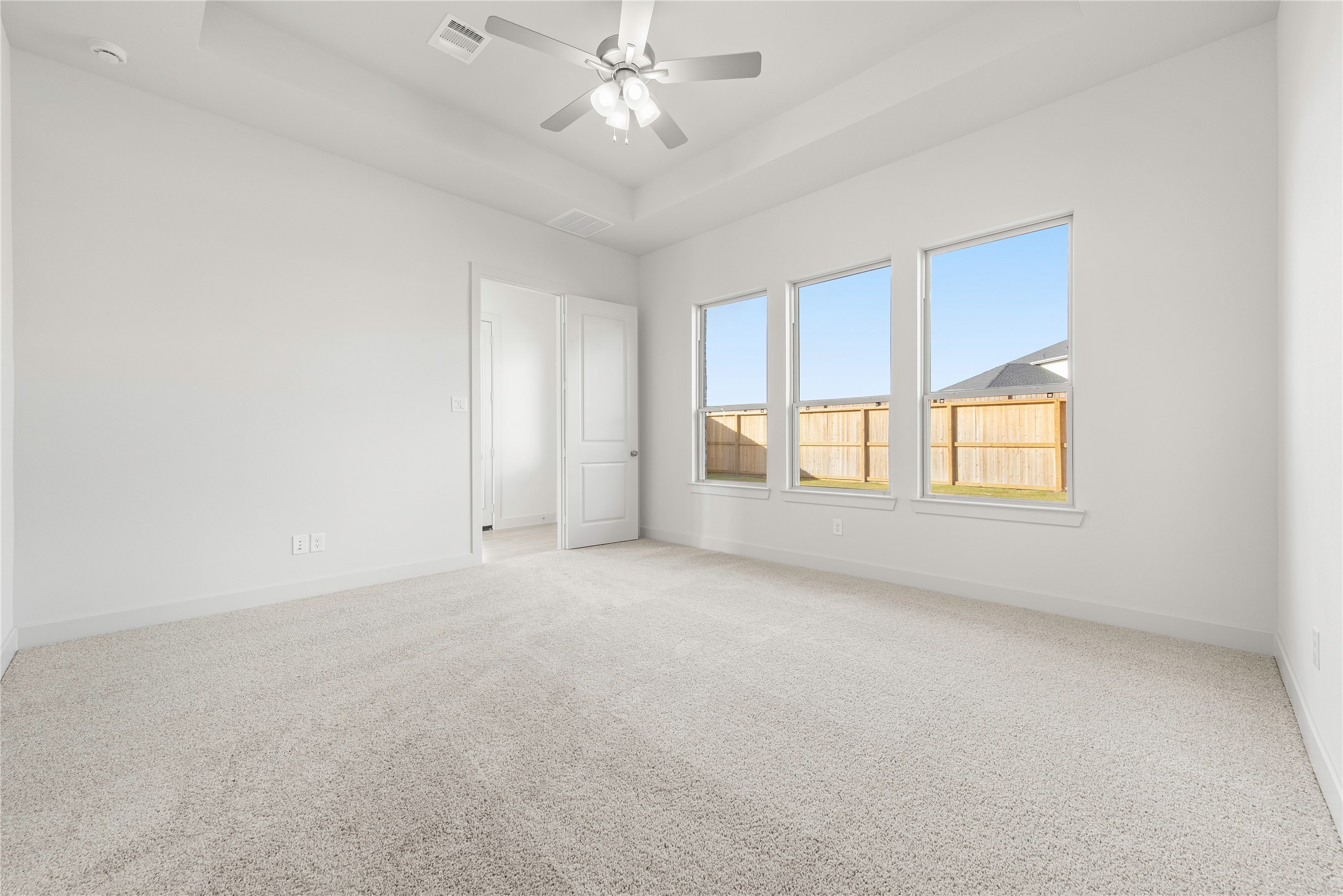 206 Sierra Stream Lane Conroe, TX 77304 - Photo 7 of 28 an empty room with chandelier fan and windows