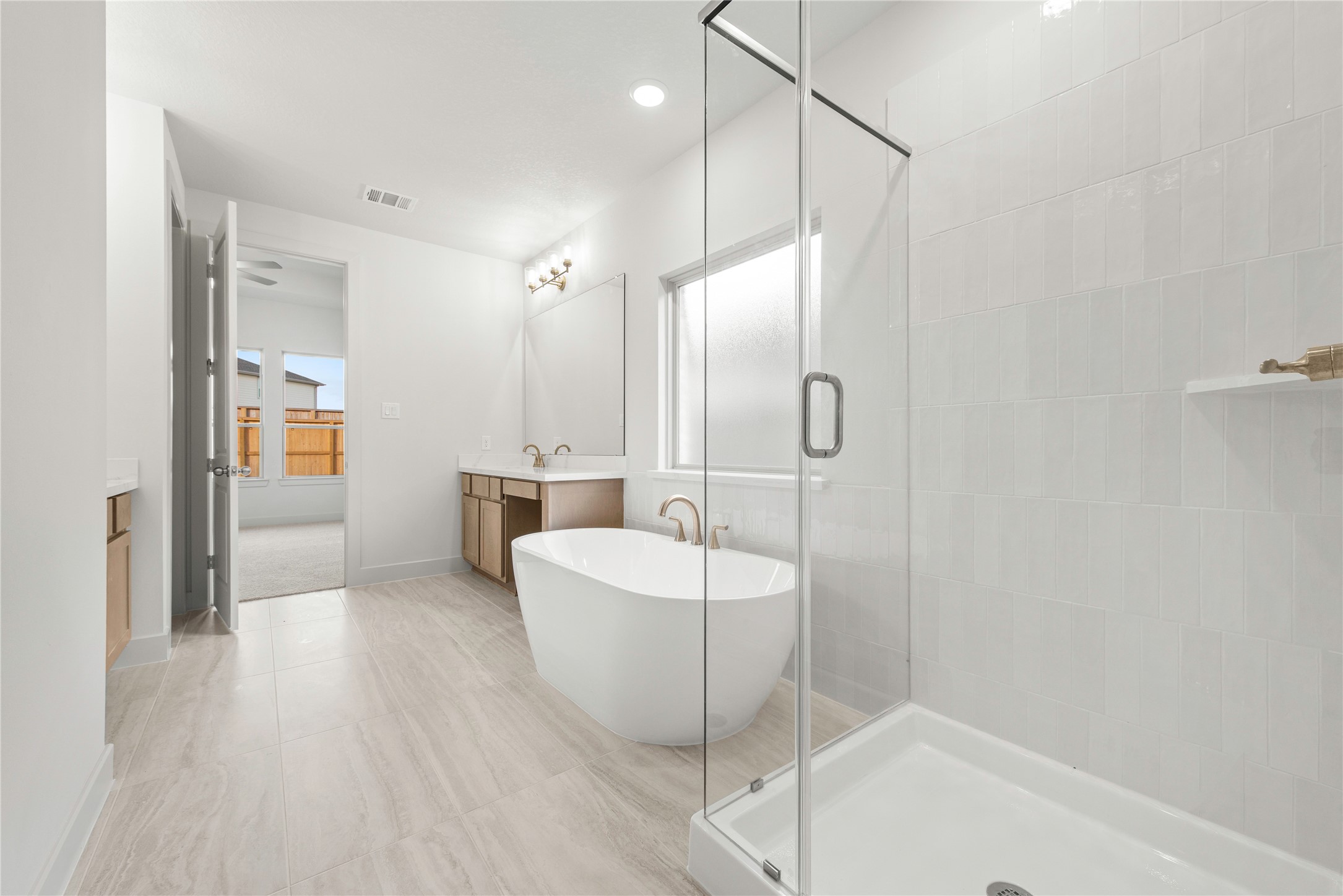 206 Sierra Stream Lane Conroe, TX 77304 - Photo 10 of 28 a spacious bathroom with a bathtub and a shower