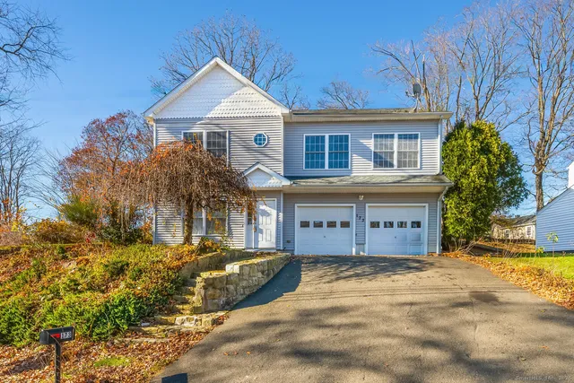 a front view of a house with a garden and yard