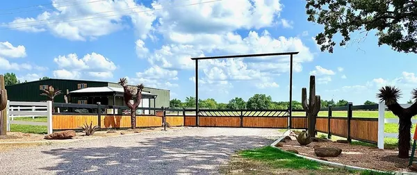 a view of a swimming pool with a patio and a yard