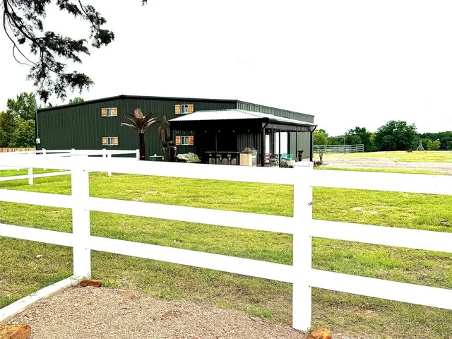 a view of a patio with table and chairs