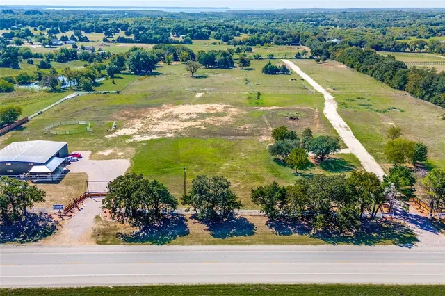 an aerial view of a houses with yard