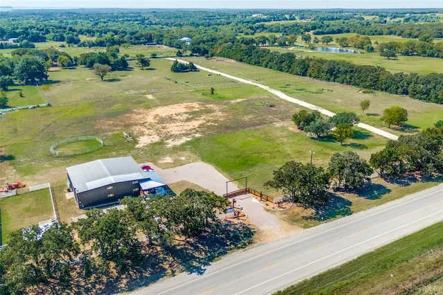 an aerial view of residential houses with outdoor space