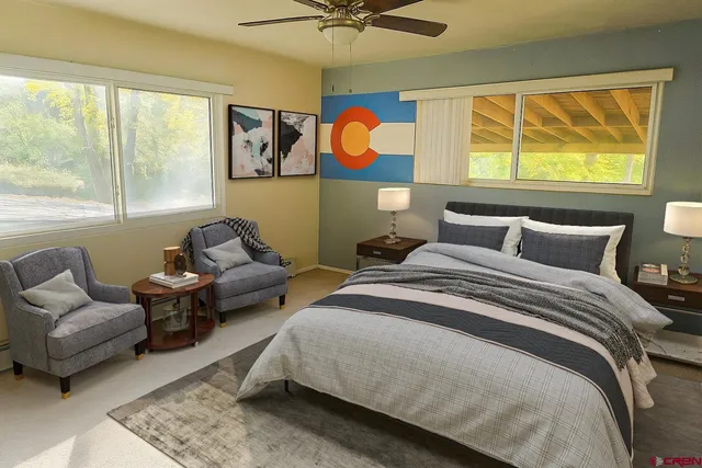 an empty room with a window and a ceiling fan