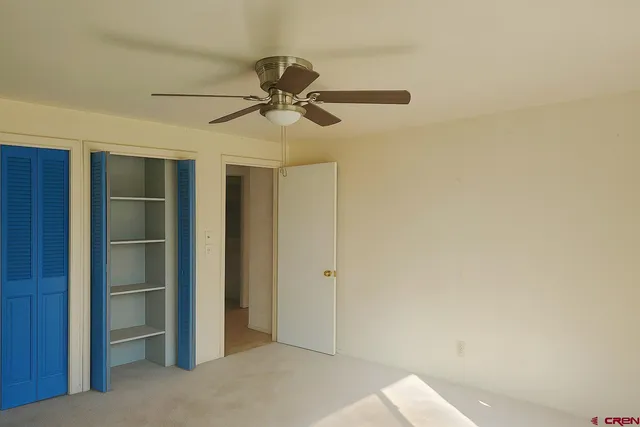 a kitchen with granite countertop a refrigerator and a stove top oven