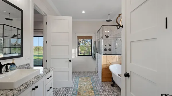 a bathroom with a double vanity sink mirror double and shower