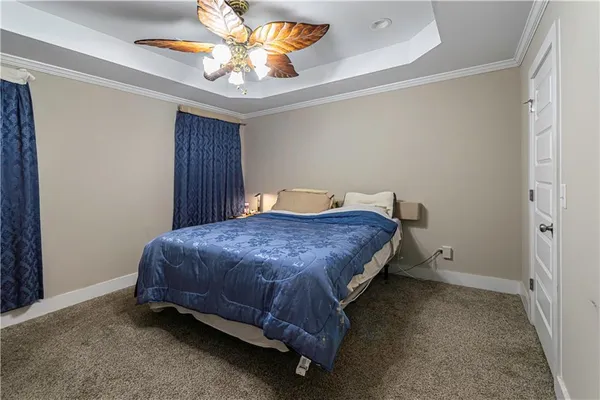 a spacious bedroom with a bed and a chandelier