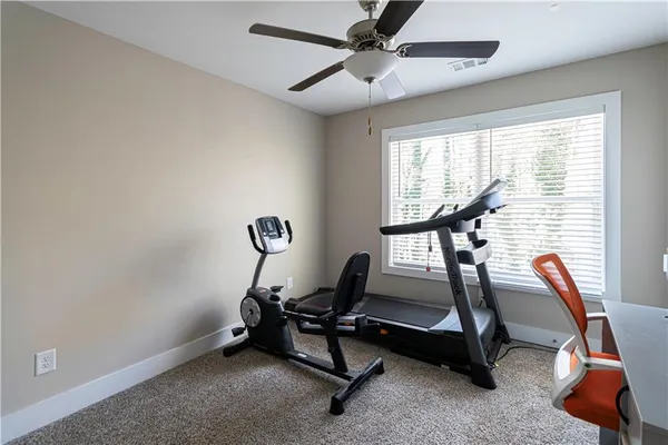 a room with gym equipment and windows
