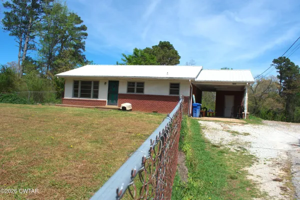 a view of a house with swimming pool and furniture