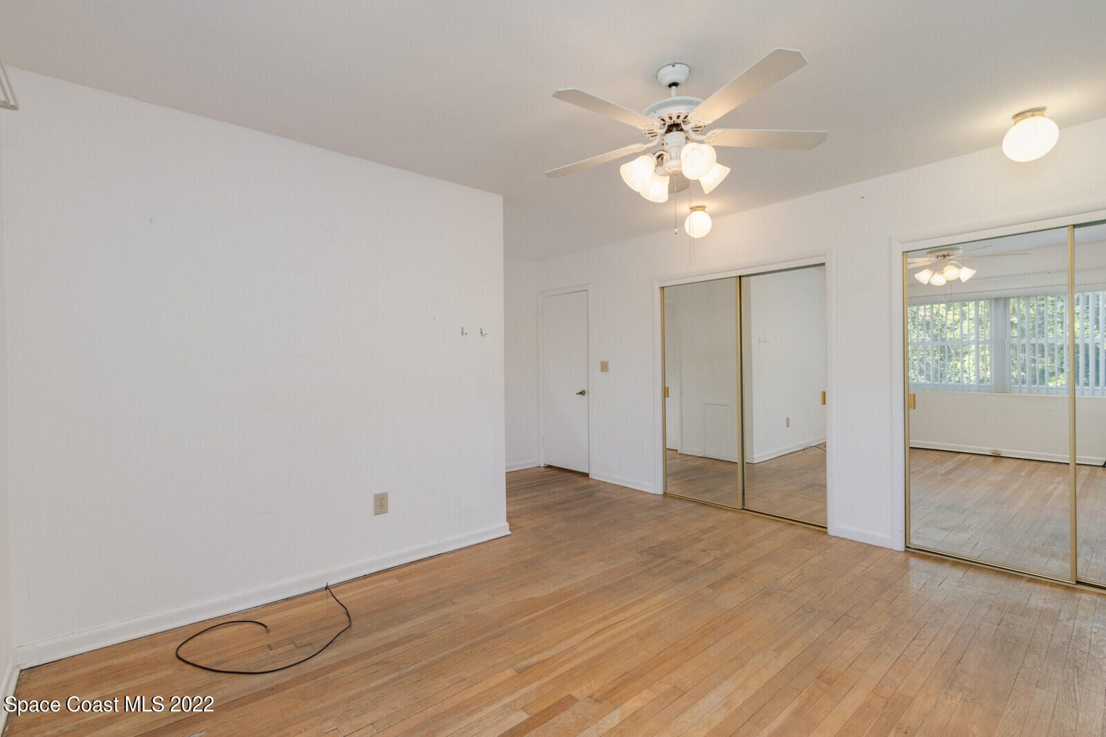 216 Dubber Road Melbourne, FL 32901 - Photo 12 of 39 wooden floor in an empty room with a window