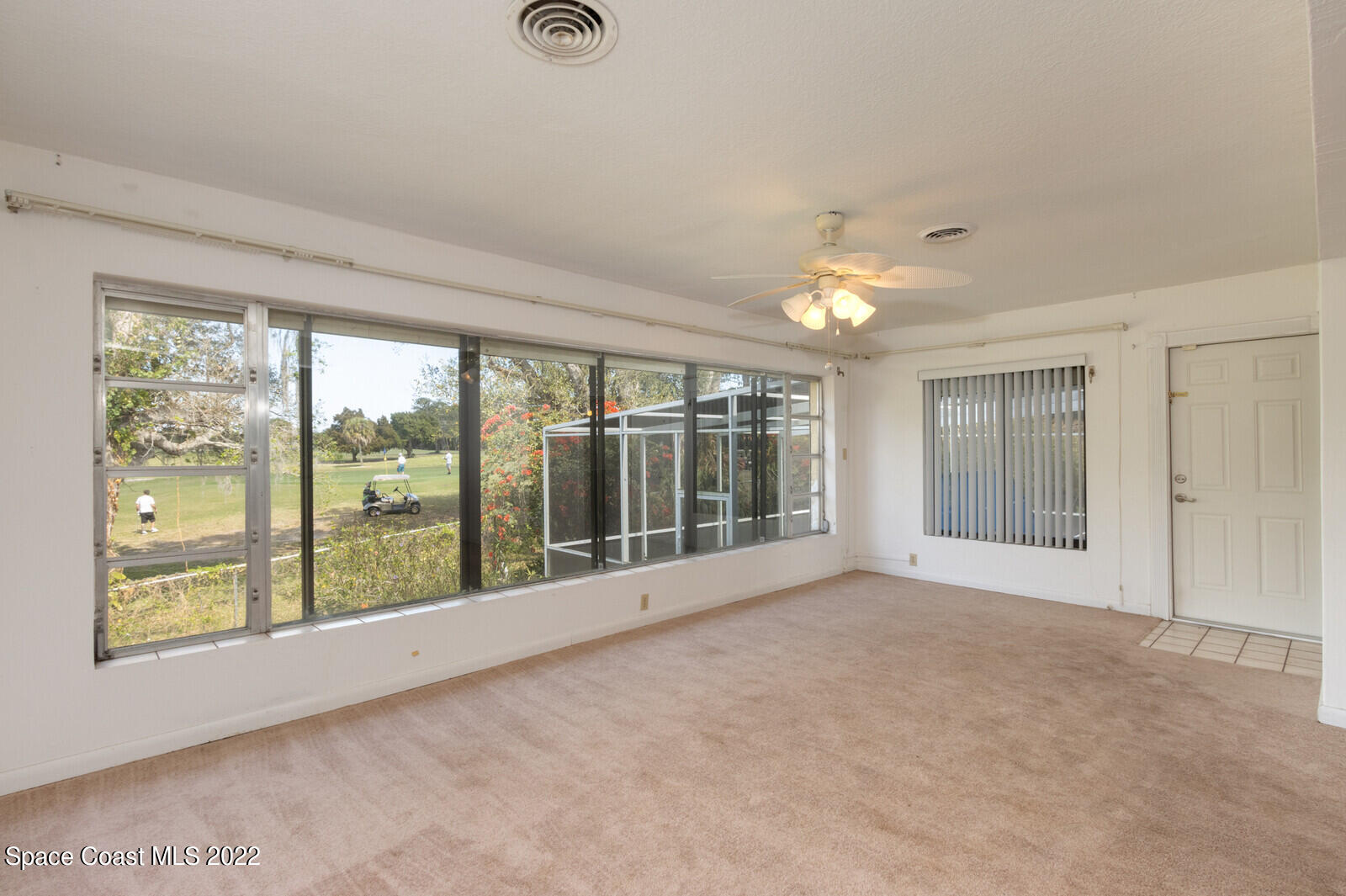 216 Dubber Road Melbourne, FL 32901 - Photo 28 of 39 an empty room with chandelier fan and windows